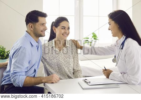 Female Doctor Consulting Young Couple Patients In Fertility Clinic About Ivf Or Iui.