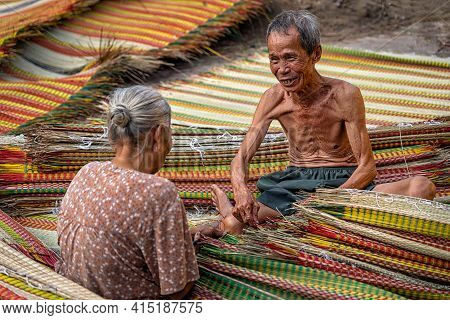 Top View Of Old Vietnamese Lover Craftsman Making The Traditional Vietnam Mats With Happiness Action