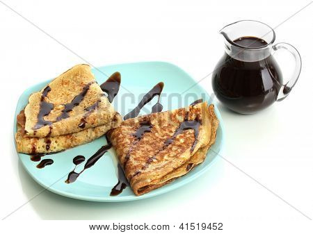 หวาน pancakes บนแผ่นกับนมข้นที่แยกต่างหากบนพื้นสีขาว