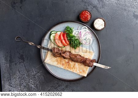 Lamb Shashlik On A Skewer In A Plate.