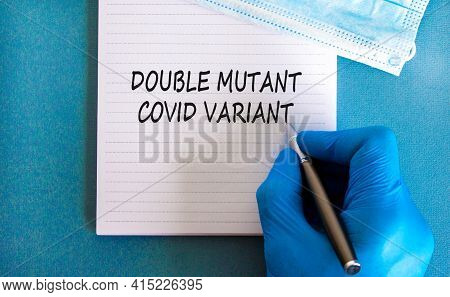 Covid-19 Double Mutant Symbol. Doctor Hand In Blue Glove With White Note. Concept Words 'double Muta
