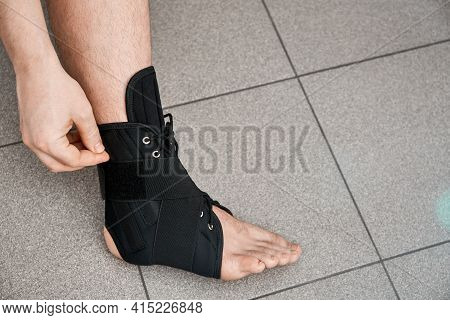 The Male Leg Is Fixed In A Medical Bandage. Ankle Fracture Or Sprain. Lacing And Tight Fit Of The Fo
