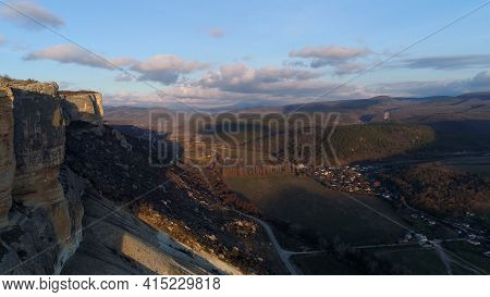 Top View Of Rocky Cliff On Background Horizon Of Mountains. Shot. Beautiful Landscape With Majestic 