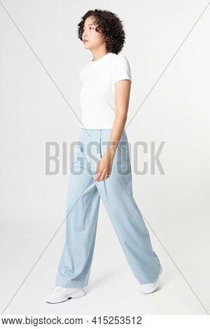 Woman in white tee and blue loose pants minimal fashion