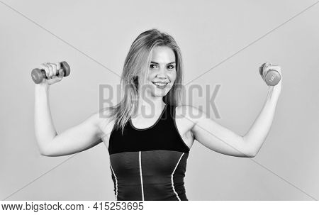 Great Progress. Slim Girl Doing Triceps Exercise With Dumbbell In The Gym. Coach Dressed In Sport Cl