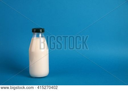 A Bottle Of Kephir Isolated On Blue Background. Fermented Food Concept. Image Contains Copy Space