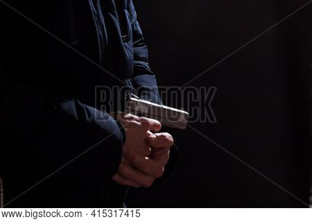 Male Hands Prerared Gun For Shooting On Black Background With Copy Space.
