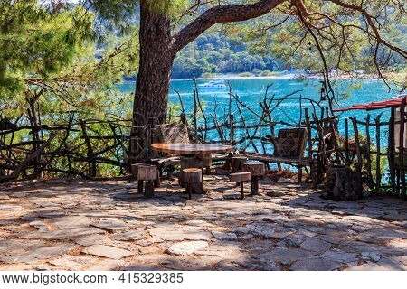 Empty Rustic Round Wooden Table And Stools In Park  In Kemer, Turkey