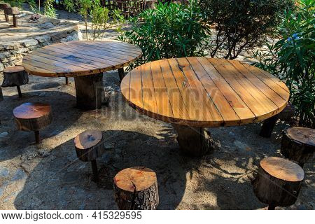 Empty Rustic Round Wooden Table And Stools In Park  In Kemer, Turkey