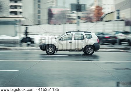Russia, Moscow - January 2021: Fast Moving Renault Duster Suv Rides On A Winter City Road. White Dac