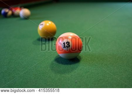 Colored Pool Balls On A Green Pool Table
