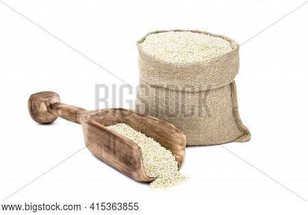 Seeds Of Sesame In A Sack Of Isolated On A White Background. Til In A Burlap Sack. Healthy Food. Ben