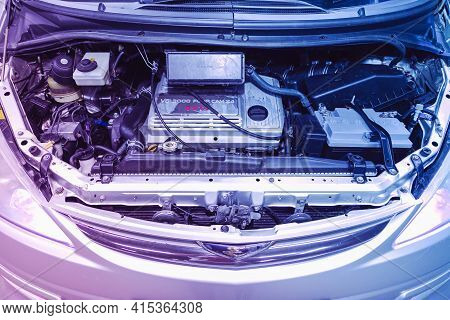 Novosibirsk, Russia - April 01 2021: Toyota Estima, Closeup Of A Clean Motor Block  Under Pink Neon 