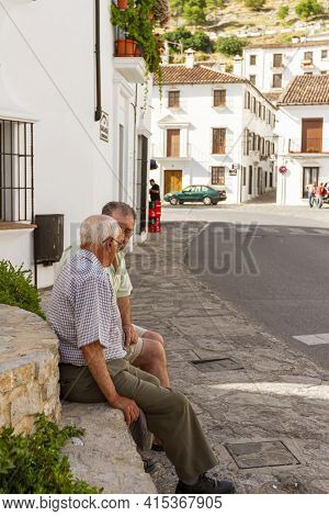 09-07-2010 Ronda, Spain: Two Elderly Spanish Men Are Sitting On A Stone By A Fountain At The Town Ce