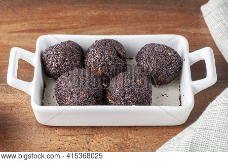 Sweet Brown Cake Balls Baked In The Oven Are Dipped In To Stump Or Syrup And Covered With Poppy Seed