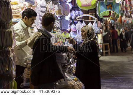 Damascus, Syria 03-28-2010: An Arabic Woman Wearing Hijab Is Shopping At An Apparel And Baby Clothin