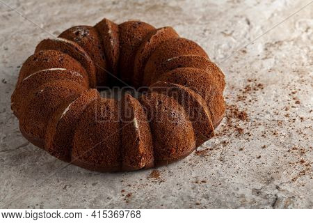 A Round Sponge Cake Fresh Out Of Oven With Crumbles And Cacao Powders Cooling On Top Of A Marble Or 