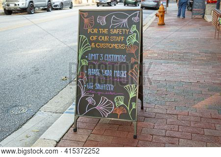 A Black Chalkboard Style Sandwich Board In Front Of A Restaurant At Historic Ellicott City. The Boar