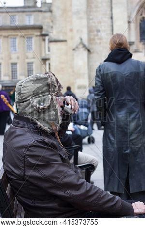 Bath, Uk 03/06/2010:  A Funny Old Man Who Is Holding A Metal Cup Of Hot Drink And A Cigarette While 
