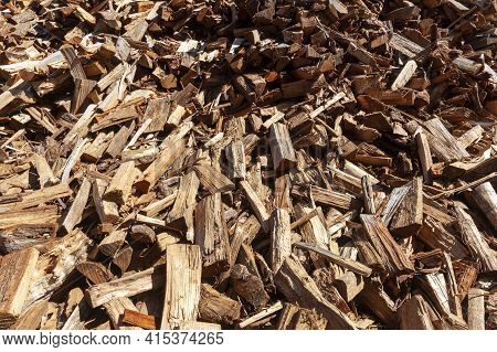A Background Image Of A Pile Of Wooden Logs Cut Into Different Shapes And Sizes And Scattered Irregu