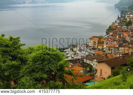 An Aerial View Of Argegno, Como A Town On The Foothills Of A Mountain And On The Coast Of Scenic Lak