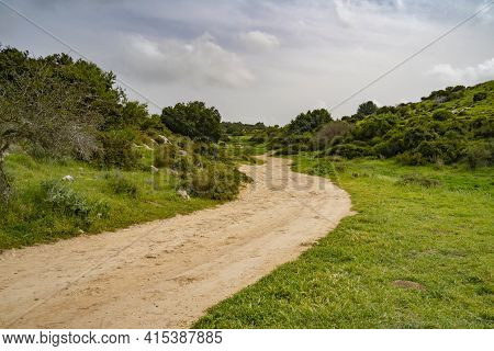A Nature Path Going Through Fields And Hills In The Adullam Region Of Israel, On An Overcast Day.
