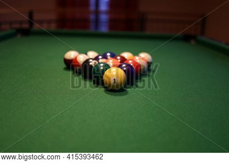 Colored Pool Balls On A Green Pool Table. Billiard Ball With Number One