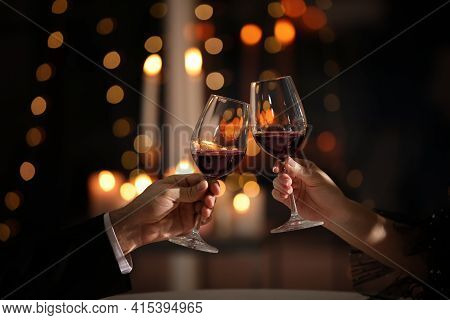 Couple Clinking Glasses At Valentine's Day Dinner In Restaurant, Closeup