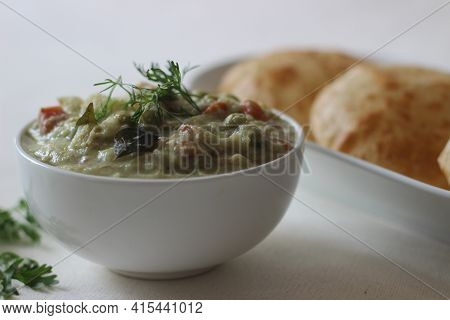 Mixed Vegetable Curry In A Coconut Cashew Gravy Served With Deep Fried Indian Flat Bread