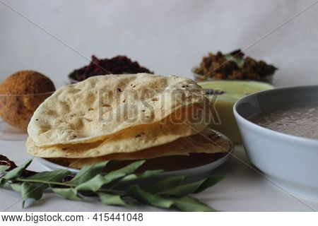 Papadum Made With Seasoned Dough Of Peeled Black Gram Flour, Either Fried Or Cooked With Dry Heat Fl