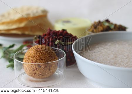 Rice Porridge Or Kanji Along With Coconut Chutney, Beetroot Potato Thoran, Stir Fried Moong, Fried P