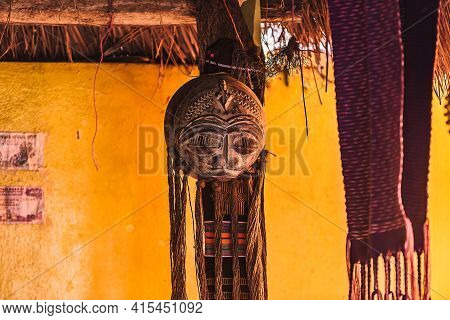 African Wooden Mask With Beard Hanging Inside A Hostel Wildcamp In The Village Of Keta Ghana West Af