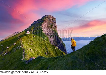 Kallur lighthouse on green hills of Kalsoy island
