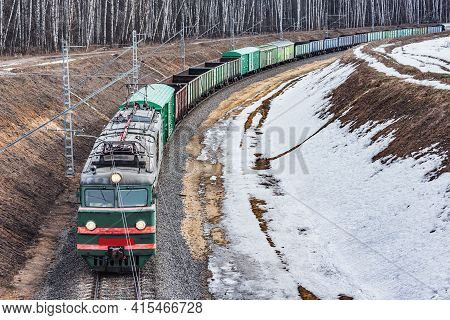 Long Freight Train Approaches To The Station.