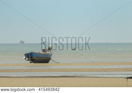 Fisherman's Fishing Boat On Sand At A Fishing Village Beach There Is An Island And Sea Background Wi