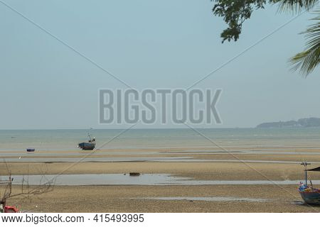 Fisherman's Fishing Boat On Sand At A Fishing Village Beach There Is An Island And Sea Background Wi