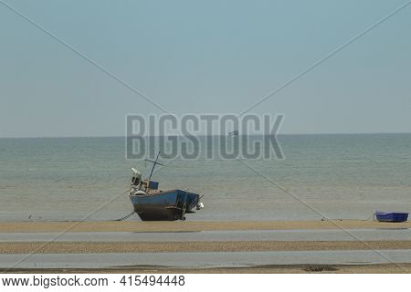 Fisherman's Fishing Boat On Sand At A Fishing Village Beach There Is An Island And Sea Background Wi