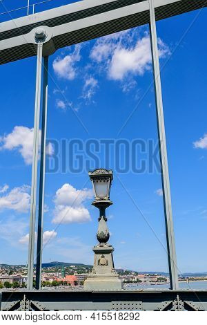 Vintage Rusted Lighting Pole With Clear Blue Sky In The Background On Széchenyi Chain Bridge Over Da