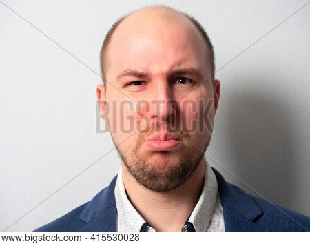 Portrait Of A Middle-aged Man In A Suit. An Aggrieved Expression. Emotions. He Rolled Out His Lower 
