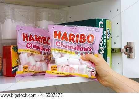Tambov, Russian Federation - January 25, 2021 Woman Hand Taking Haribo Chamallows Package Out Of Cup