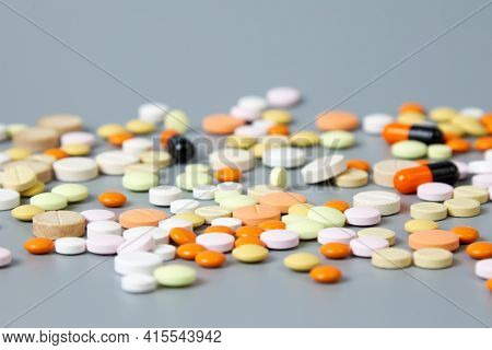 Colorful Pills On A Gray Background. The Concept Of Drug Diversity In The Modern World