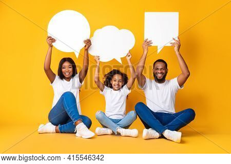 Smiling Black Family Hoding Speech Bubbles At Studio