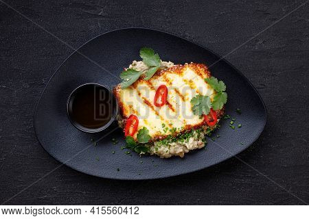 Grilled Haloumi Cheese On A Black Plate