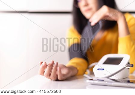 Women Using Blood Pressure & Heart Rate Monitors In Yourself At Home