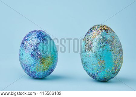 Blue Painted Eggs With Bright Shiny Gliter On Blue Background
