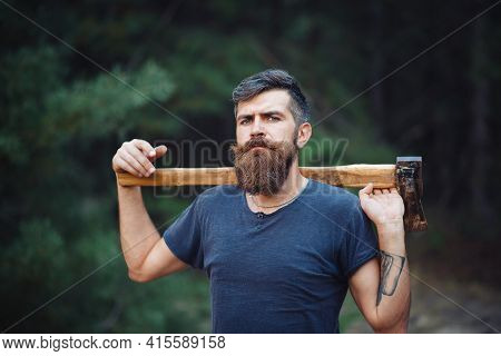Gray-haired Stylish Brutal Bearded Man In A Dark Sleeveless T-shirt With A Large Mustache And Gray H