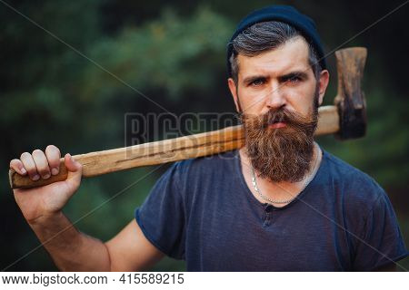 Gray-haired Stylish Brutal Bearded Man In A Dark Sleeveless T-shirt With A Large Mustache And Gray H