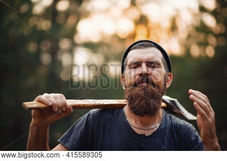 A Wet Brutal Bearded Man In A Dark Sleeveless T-shirt With A Large Mustache And Gray Hair Holds An I
