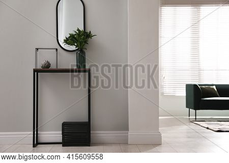 Console Table With Decor And Mirror On Light Wall In Hallway. Interior Design