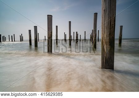 Long Exposure Seascape In Retro Colors. Taken At The North Sea In Petten With The Pole Village In Th